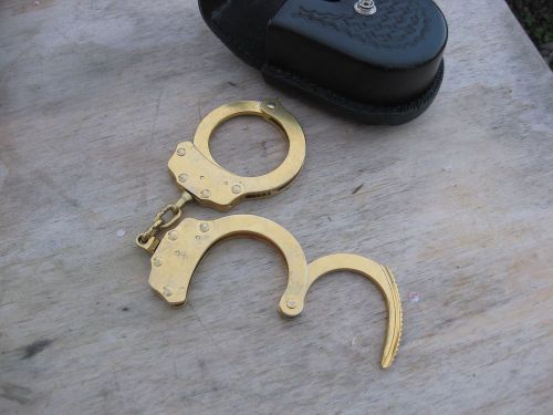 Gold Peerless handcuffs in Safariland tooled leather case