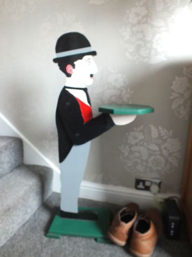 Dumb waiter in the figural form of  Charlie Chaplin butler, on wooden base