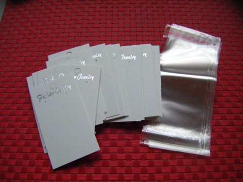 100 WHITE EARRING JEWELRY DISPLAY HANGING CARDS AND 100 CLEAR SELF ADHESIVE BAGS
