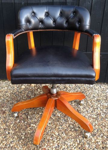 Good quality heavy captains swivel office chair with black button back leather for sale
