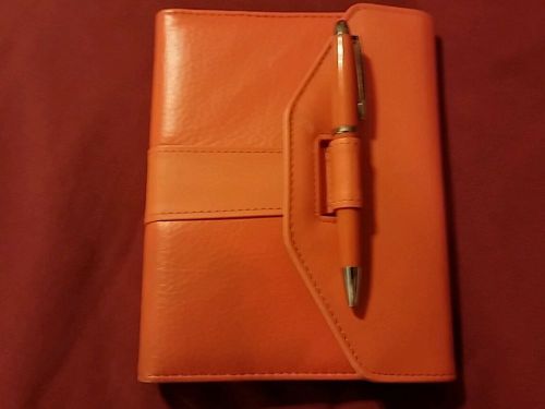 Orange personal organizer with matching pen for sale