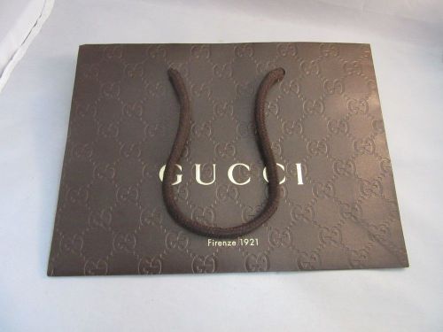 Embossed paper gift, shopping bag from Gucci designer store. Brown,gold logo 1