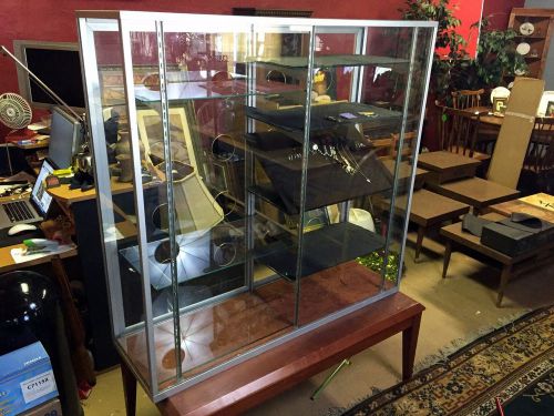 Glass display case with glass shelving and locking rear doors
