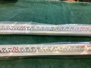 Two Berger 8 foot aluminum telescoping grade rods, new old stock, feet and inche