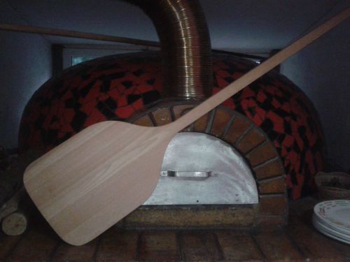 wooden pizza paddle into the furnace
