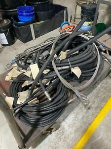 assortment hydraulic hoses, some with fittings.