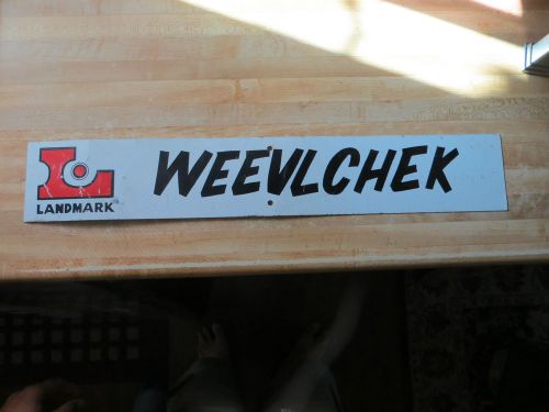 Landmark logo Weevlchek advertising steel metal company display business sign