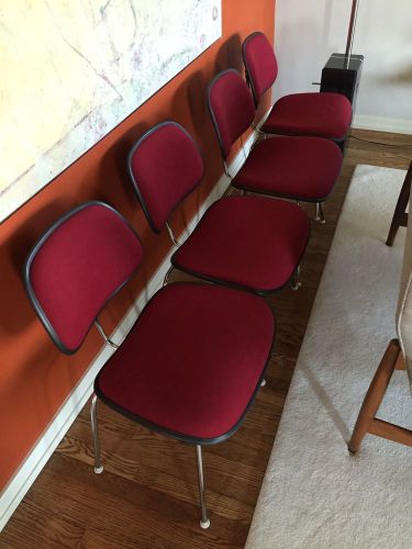 Four Upholestred Herman Miller Eames DCM Chairs.