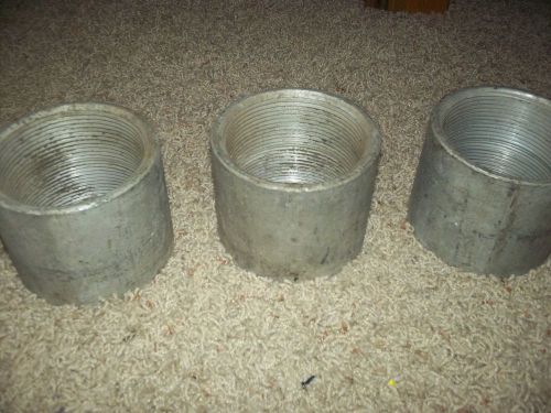 LOT OF THREE 4 INCH OUTSIDE DIAMETER CAST IRON PIPE COUPLING,3 1/4 INCH INSIDE