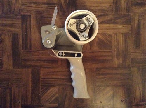 Packaging tape gun with new roll of tape