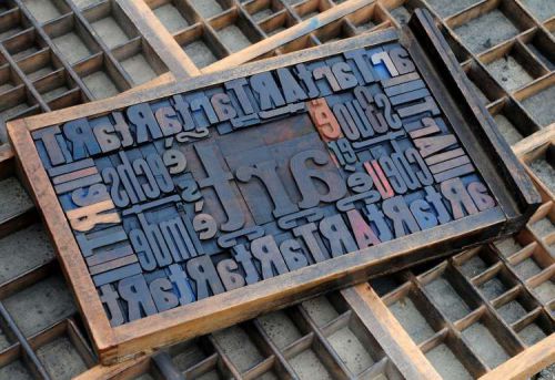 Collage &#034;ART&#034; made of letterpress wood type characters in antique drawer old