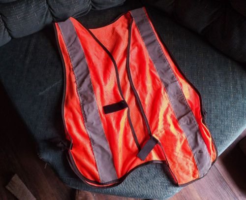 Used silver and orange safety vest. Reflective silver strips.