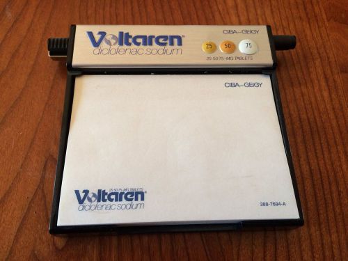 USED SILVER/BLACK VOLTAREN (DICLOFENAC SODIUM) NOTEPAD, PAPERWEIGHT, AND PEN