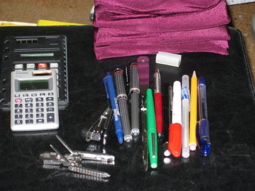 Collection of school supplies pens pencil calculators book covers multitool