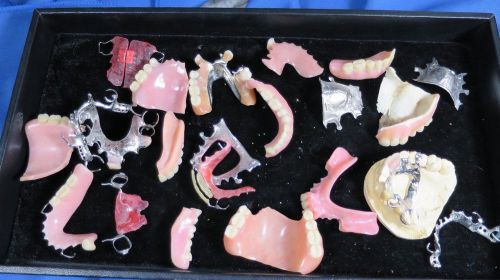Lot of 22 items that include dentures, metal from partials, retainers, and misc