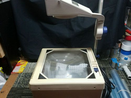 ELMO HP-1102 OVERHEAD PROJECTOR AND REPLACEMENT BULB AND 4 TRANSPARENCIES INC.