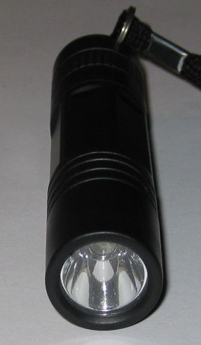 Compact and light led flashlight - weighs under 1 oz - uses 1 aa  strap included for sale