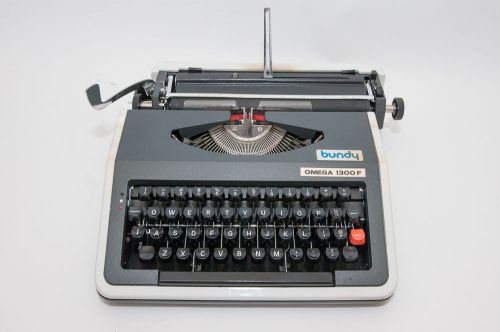 Omega 1300F manual typewriter with case and papers