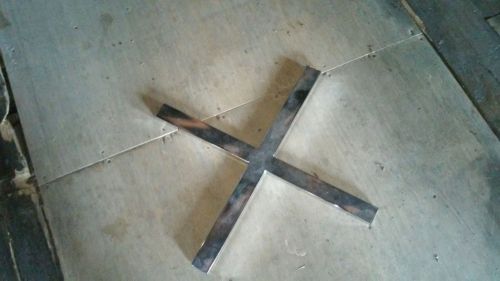 Metal clothing part that is the X that holds the arms together at the top of the