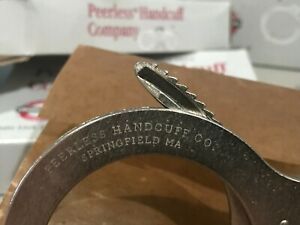 Peerless Chain Link Model 500 Handcuffs(NO KEYS) but you can use any peerles key