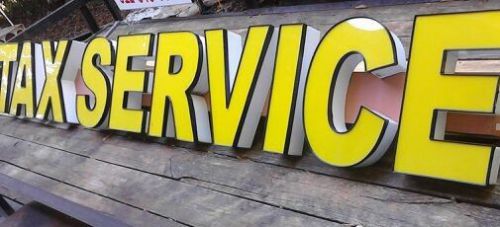 Used TAX SERVICE sign for storefront